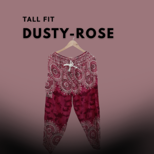 Pair of tall fit harem pants in dusty rose with intricate white mandala patterns, displayed on a hanger against a muted rose background