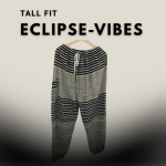 Tall-fit harem pants in black and grey eclipse-inspired print, hanging on a wooden hanger against a gradient grey background.